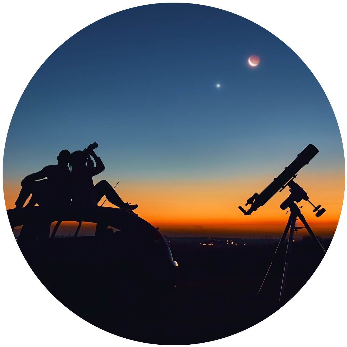 Two people viewing the stars and a telescope